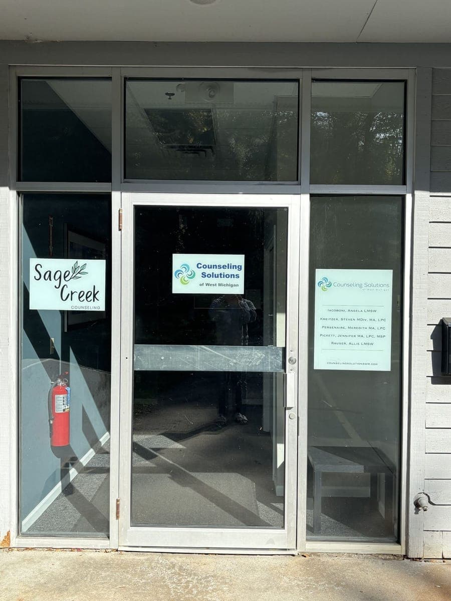 The glass entrance door with the Counseling Solutions of West Michigan sign on it.