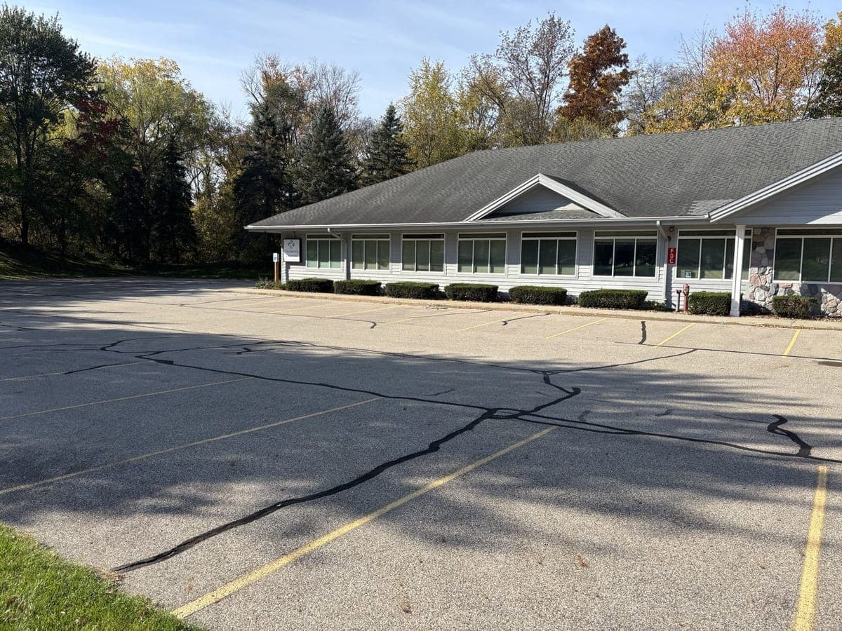 The parking lot running along the side of the building, with the Counseling Solutions sign at the far end of the building.